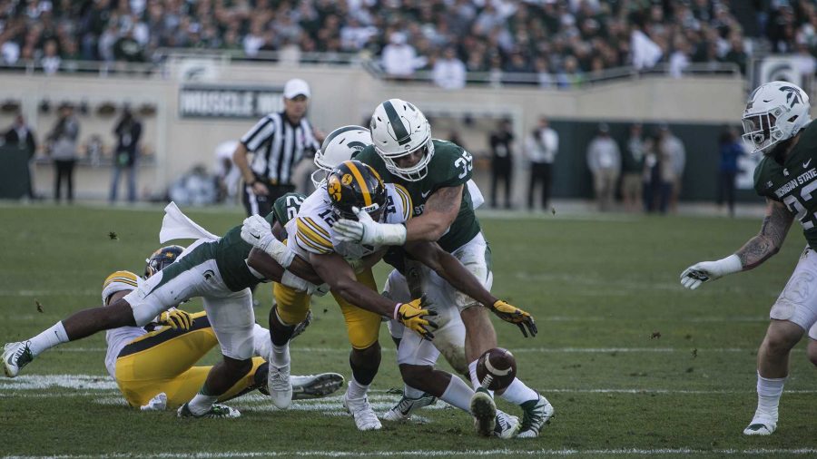 Iowa+wide+receiver+Brandon+Smith+%2812%29+attempts+to+recover+a+fumble+forced+by+Michigan+States+Joe+Bachie+during+the+game+between+Iowa+and+Michigan+State+at+Spartan+Stadium+on+Saturday%2C+Sept.+30%2C+2017.+The+Hawkeyes+fell+to+the+Spartans+with+a+final+score+of+10-17.+%28Ben+Smith%2FThe+Daily+Iowan%29