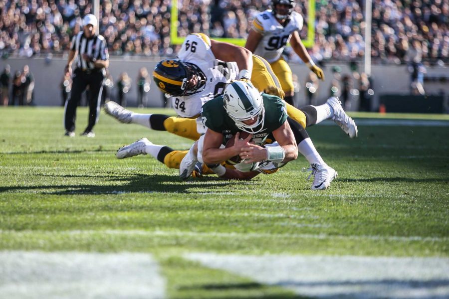 Iowas+A.J.+Epenesa+tackles+Michigan+State+quarter+back+Brian+Lewerke+during+the+game+between+Iowa+and+Michigan+State+at+Spartan+Stadium+on+Saturday%2C+Sept.+30%2C+2017.+The+Hawkeyes+fell+to+the+Spartans+with+a+final+score+of+10-17.+%28Ben+Smith%2FThe+Daily+Iowan%29
