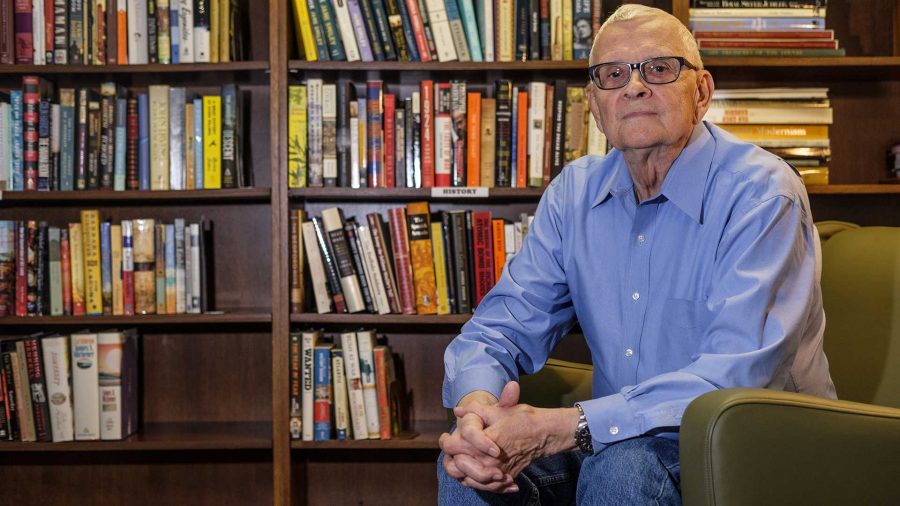 Carl Orgren sits in the library of the Oakknoll reitirement home on Wednesday, September 27, 2017. Orgren was a key part of the introduction of information technology to the University of Iowa School of Library and Information Sciences. (Nick Rohlman/The Daily Iowan)