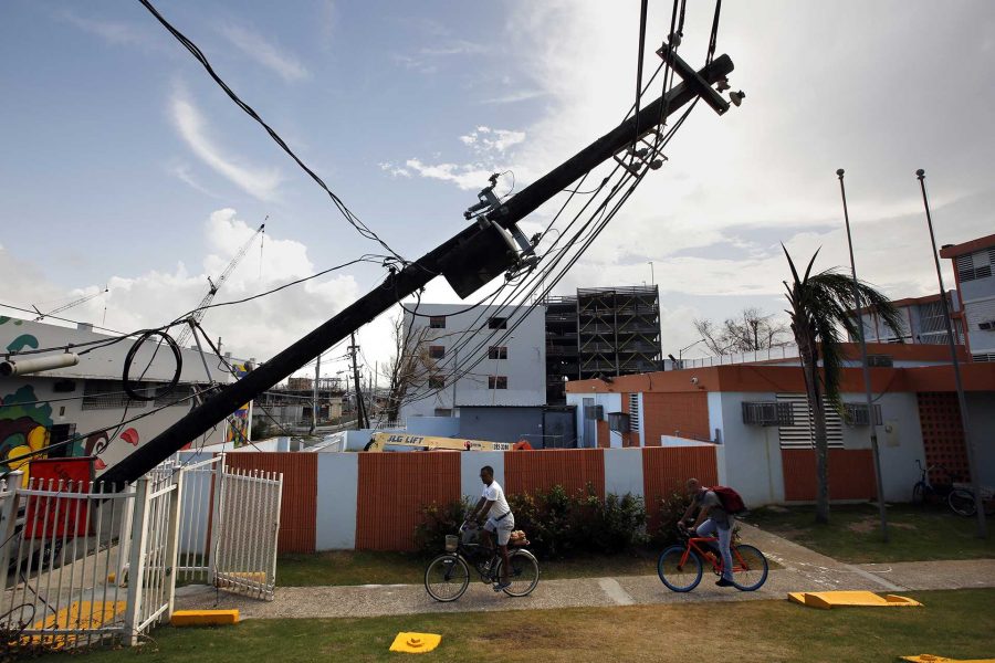 In downtown San Juan, Puerto Rico, electric lines lie in the road and block apartment complexes, like the Residencia Parque San Lorenzo, on Thursday, Sept. 28, 2017. (Carolyn Cole/Los Angeles Times/TNS)