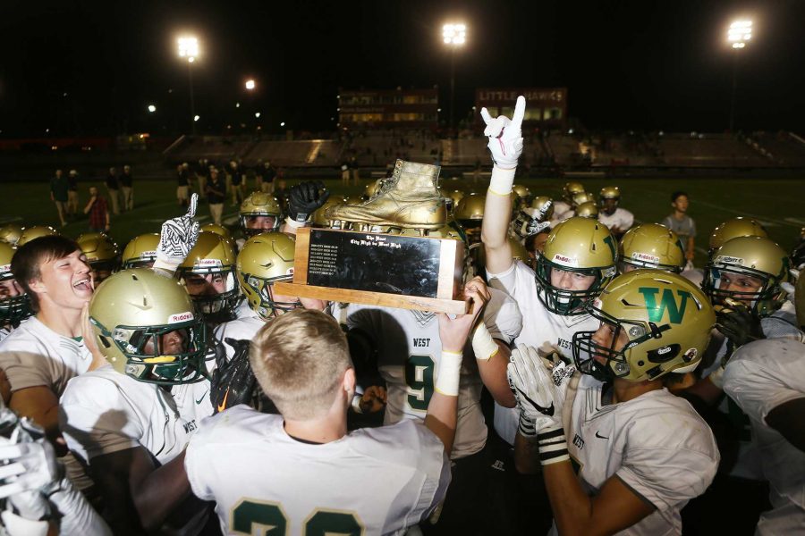 West Highs Brendan Mott lifts the Boot with teammates after being injured during a 4A varsity high school football game between Iowa City High and West High at Bates Field in Iowa City on Friday, Sept. 15, 2017. (Joseph Cress/The Daily Iowan)