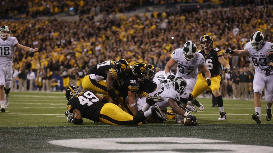 Michigan State running back LJ Scott scores a touchdown putting them in the lead with 27 seconds left in the fourth quarter during the Big Ten Championship against Iowa in Lucas Oil Stadium in Indianapolis, Indiana on Saturday, Dec. 5, 2015. The Spartans defeated the Hawkeyes, 16-13. (The Daily Iowan/Alyssa Hitchcock)
