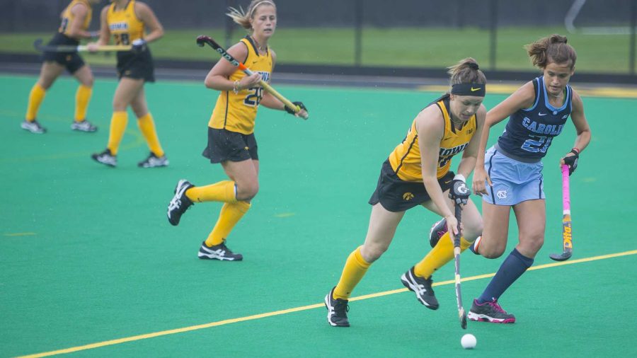 Iowas Madeleine Murphy (26) runs from UNCs Eva Smolenaars (21) during a field hockey game during the Big Ten/ACC Challenge at Grant Field in Iowa City on Sunday, Aug. 27, 2017. The Hawkeyes fell to the Tarheels, 3-0. (Lily Smith/The Daily Iowan)