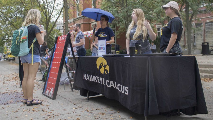 The+Hawkeye+Caucus+speaks+to+students+on+the+T.+Anne+Cleary+Walkway+on+Tuesday%2C+September+26%2C+2017.+UISG+hosted+tables+where+students+could+register+to+vote.