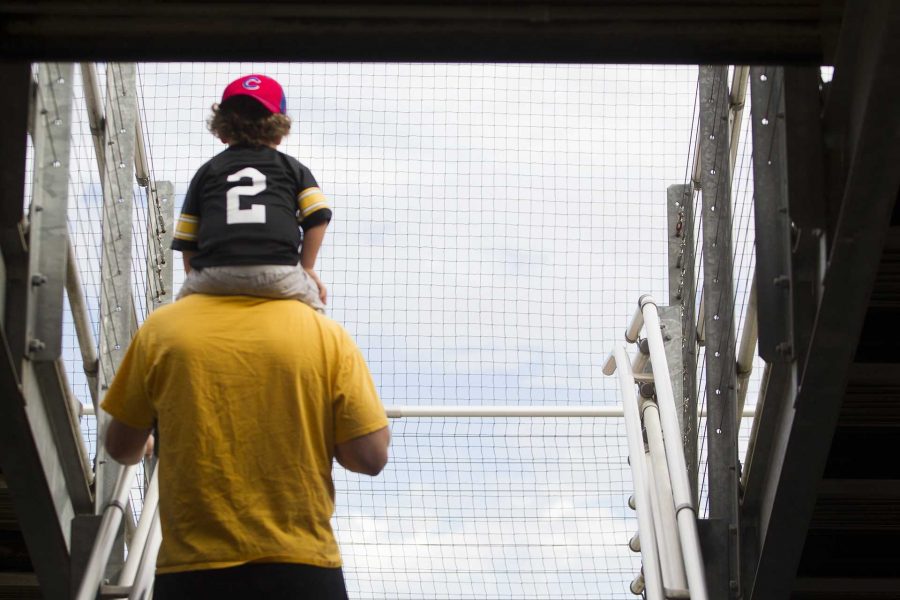 A dad helps a child view the game at Pearl Field Softball Complex on Sunday, Oct. 1, 2017. The Hawkeyes defeated the Drake Bulldogs 6-5. (Ashley Morris/The Daily Iowan)