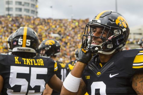 Iowa defensive back Geno Stone smiles on the sideline after recovering an onside kick during an NCAA football game between Iowa and Illinois in Kinnick Stadium on Saturday, Oct. 7, 2017.  The Hawkeyes defeated the Fighting Illini, 45-16. (Joseph Cress/The Daily Iowan)