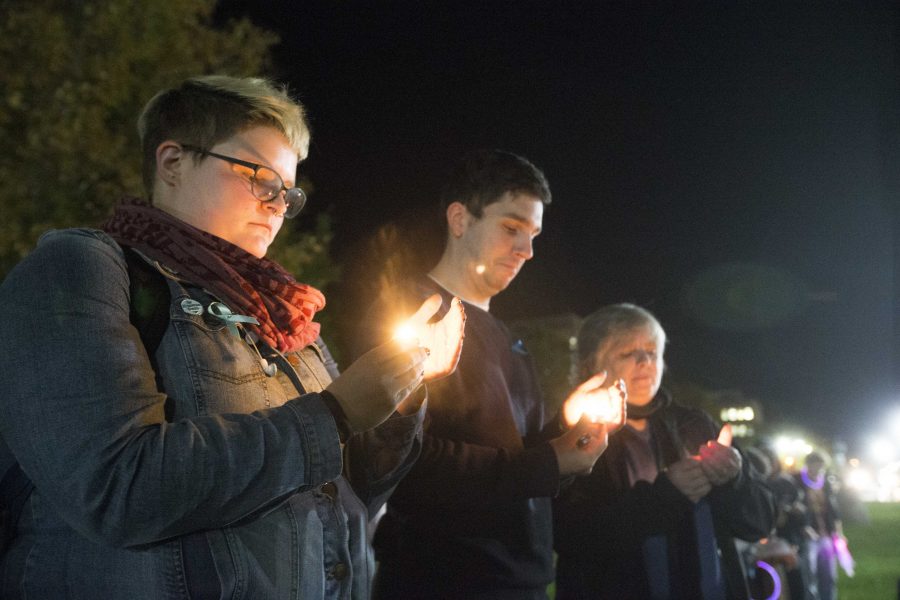 From+left%3A+UI+senior+Ellen+Kuehnle+and+Womens+Resource+and+Action+Center+employees+Cody+Howell+and+Laurie+Haag+hold+candles+during+the+UI+Sister+Vigil+for+Survivors+of+Campus+Sexual+Assault+on+the+Pentacrest+on+Tuesday%2C+Oct.+17%2C+2017.+The+event+included+letter+writing+to+Iowa+senators+and+the+signing+of+thank+you+state+of+Iowa+flags+to+senators+fighting+the+withdrawal+of+Title+IX+protections+for+survivors+of+sexual+assault.+%28Lily+Smith%2FThe+Daily+Iowan%29