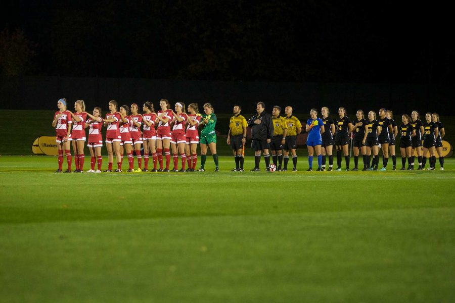 The Hawkeyes and the Badgers line up for the national anthem at the Iowa Soccer Complex in Iowa City on Saturday, October 21, 2017. The Hawkeyes fell to the Badgers 3-0 (Paxton Corey/The Daily Iowan)