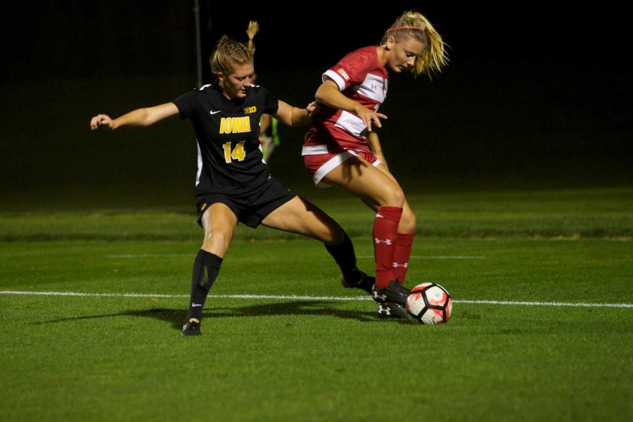 Iowa Defender Leah Moss challenges Chloe Knudtson along the touch line at the Iowa Soccer Complex in Iowa City on Saturday, October 21, 2017. The Hawkeyes fell to the Badgers 3-0 (Paxton Corey/The Daily Iowan)