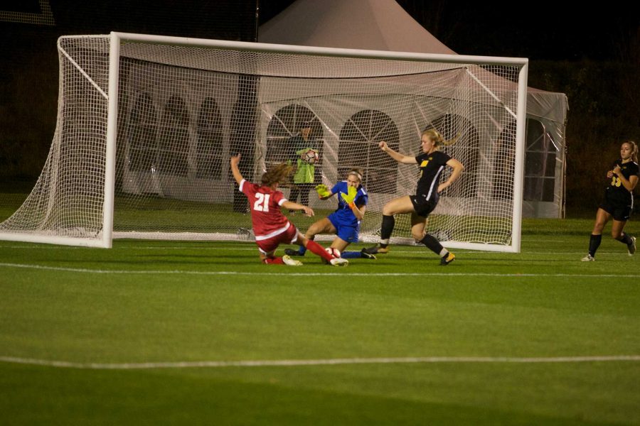 Wisconsins Becca Harrison scores a sliding goal at the Iowa Soccer Complex in Iowa City on Saturday, October 21, 2017. The Hawkeyes fell to the Badgers 3-0 (Paxton Corey/The Daily Iowan)