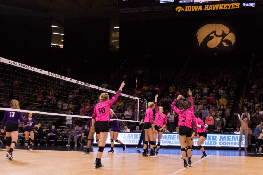 Iowa Hawkeye volleyball players celebrate the final point of the match against the Northwestern University Wildcats on Saturday, Oct. 21, 2017. The Hawkeyes defeated the Wildcats three sets to zero. (David Harmantas/The Daily Iowan)