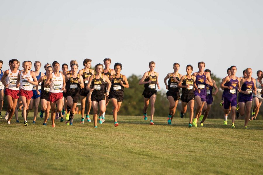 The Iowa Mens Cross Counntry Team springs away from the starting boxes at the Hawkeye Invitational Cross Country meet on Friday, September 1, 2017. (David Harmantas/The Daily Iowan)