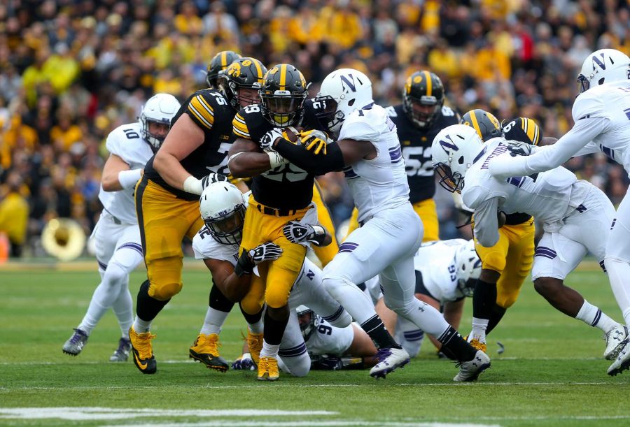 FILE - Northwestern linebacker Nate Hall tackles Iowa running back LeShun Daniels during the game between Iowa and Northwestern in Iowa City on Saturday, October 1, 2016. The Wildcats defeated the Hawkeyes 38-31. (The Daily Iowan/file)