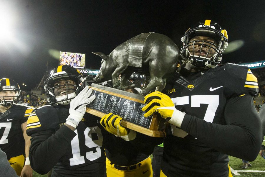 Iowas+Miles+Taylor+and+Chauncey+Golston+carry+the+Floyd+of+Rosedale+trophy+after+an+Iowa%2FMinnesota+football+game+in+Kinnick+Stadium+on+Oct.+28.+The+Hawkeyes+defeated+the+Golden+Gophers%2C+17-10.+%28Joseph+Cress%2FThe+Daily+Iowan%29