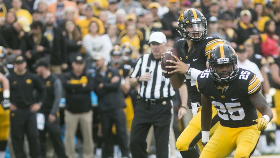 Iowa quarterback Nate Stanley looks to pass while getting a block by Akrum Wadley during an NCAA football game between Iowa and Illinois in Kinnick Stadium on Saturday, Oct. 7, 2017.  The Hawkeyes defeated the Fighting Illini, 45-16. (Joseph Cress/The Daily Iowan)