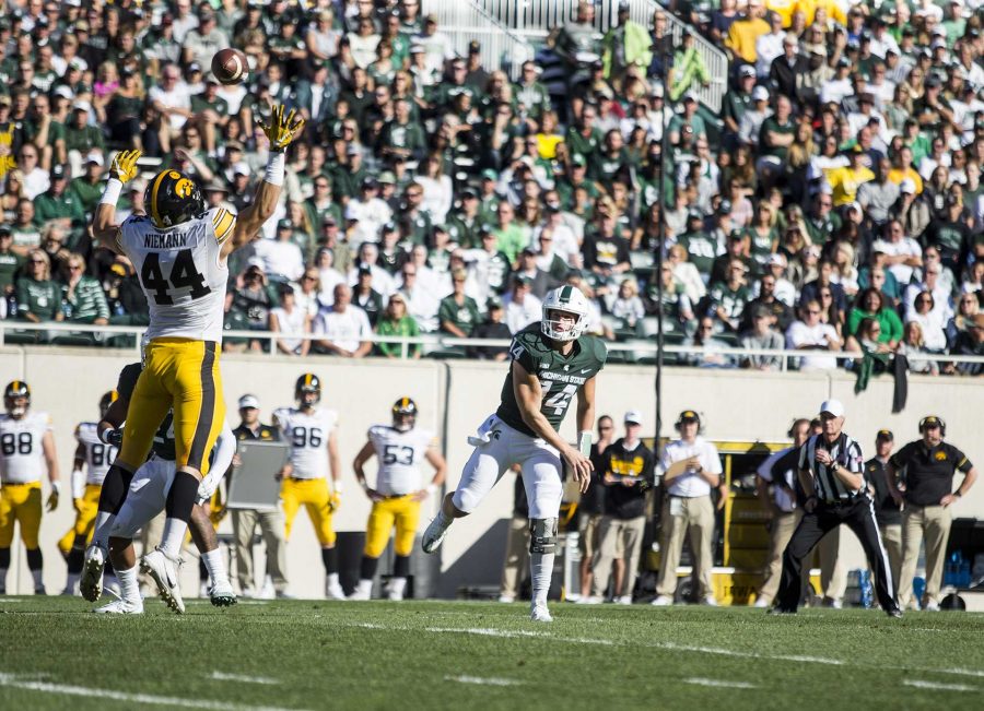 Iowa Linebacker Ben Niemann attempts to swat a pass by Michigan State Quarterback Brian Lewerke during the game between Iowa and Michigan State at Spartan Stadium on Saturday Sept. 30, 2017. The Spartans defeated the Hawkeyes 17-10. (Nick Rohlman/The Daily Iowan)