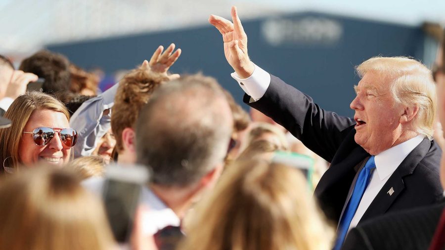 President Donald Trump greets supporters after arriving at Love Field in Dallas on Wednesday, Oct. 25, 2017. (Andy Jacobsohn/Dallas Morning News/TNS)