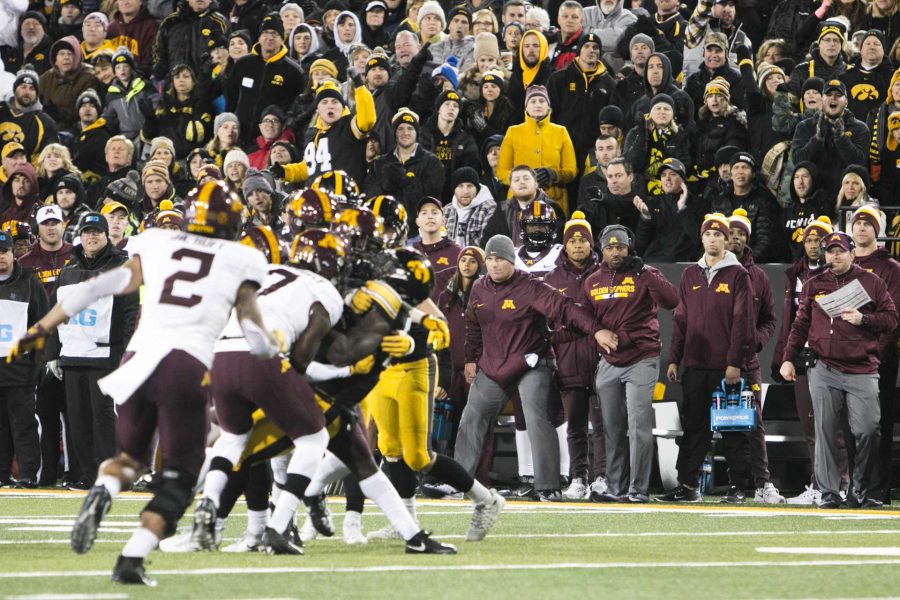 Minnesota coaches watch while players tackle Iowa running back James Butler to force a fumble during an Iowa/Minnesota football game in Kinnick Stadium on Saturday, Oct. 28, 2017. The Hawkeyes defeated the Golden Gophers, 17-10. (Joseph Cress/The Daily Iowan)