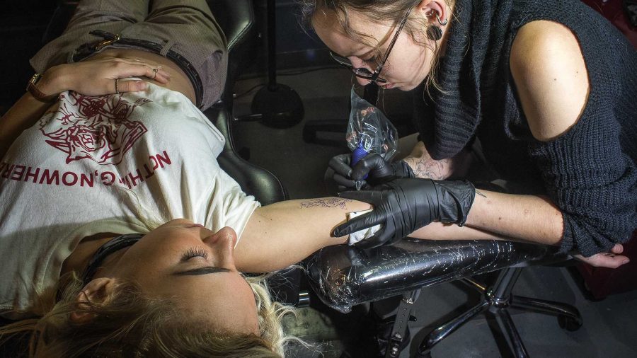 UI philosophy student, Rachel Edelman, gets her 7th tattoo at Black Angel Body Arts on Wednesday, Oct. 18, 2017. The tattoo artist, Nikki Powills, has been working in the industry since 2007 and enjoys the collaborative effort to turn a customers idea into reality. (James Year/The Daily Iowan)