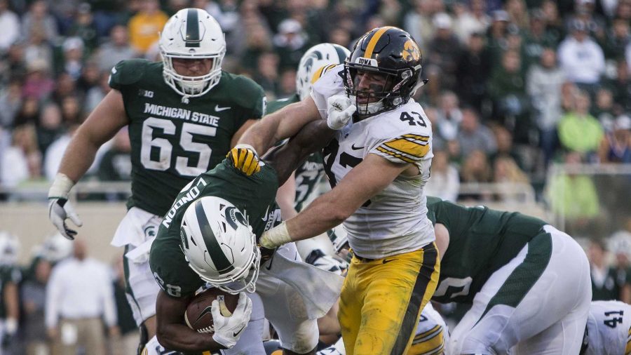 Iowa linebacker Josey Jewell (43) pushes Michigan State's Madre London to the ground during the game between Iowa and Michigan State at Spartan Stadium on Saturday, Sept. 30, 2017. The Hawkeyes fell to the Spartans with a final score of 10-17. (Ben Smith/The Daily Iowan)