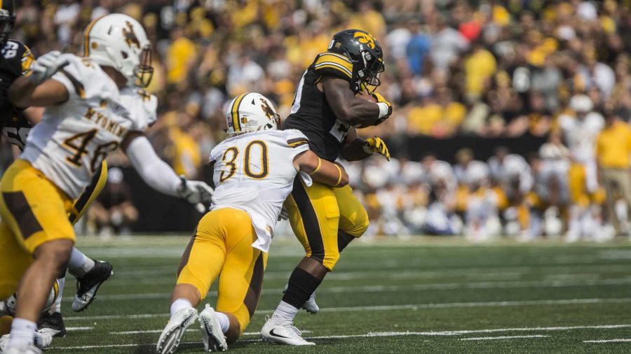 Iowa+running+back+James+Butler+breaks+a+tackle+during+the+season+opener+against+Wyoming+on+Saturday%2C+Sep.+2%2C+2017.+The+Hawkeyes+went+on+to+defeat+the+Cowboys+24-3.+%28Ben+Smith%2FThe+Daily+Iowan%29