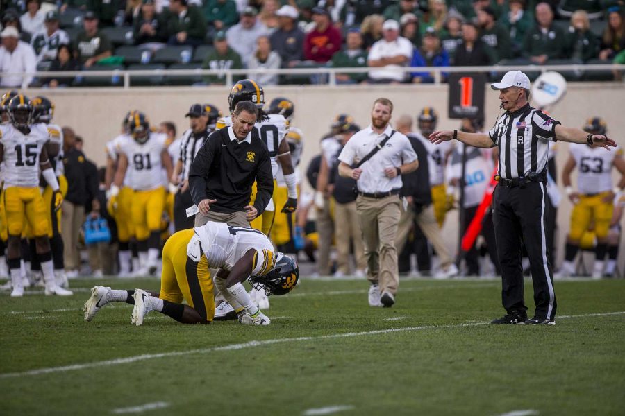 An Iowa Athletic trainer evaluates defensive back Michael Ojemudia during the game between Iowa and Michigan State at Spartan Stadium on Saturday Sept. 30, 2017. The Spartans defeated the Hawkeyes 17-10. (Nick Rohlman/The Daily Iowan)