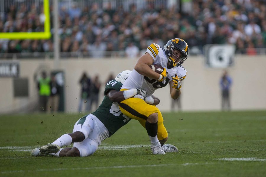 Iowa tight end TJ hockenson is tackled during the game between Iowa and Michigan State at Spartan Stadium on Saturday Sept. 30, 2017. The Spartans defeated the Hawkeyes 17-10. (Nick Rohlman/The Daily Iowan)