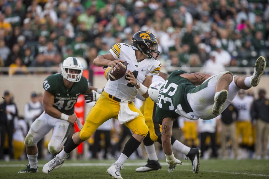 Iowa quarterback Nate Stanley tries to avoid a blitz during the game between Iowa and Michigan State at Spartan Stadium on Saturday Sept. 30, 2017. The Spartans defeated the Hawkeyes 17-10. (Nick Rohlman/The Daily Iowan)