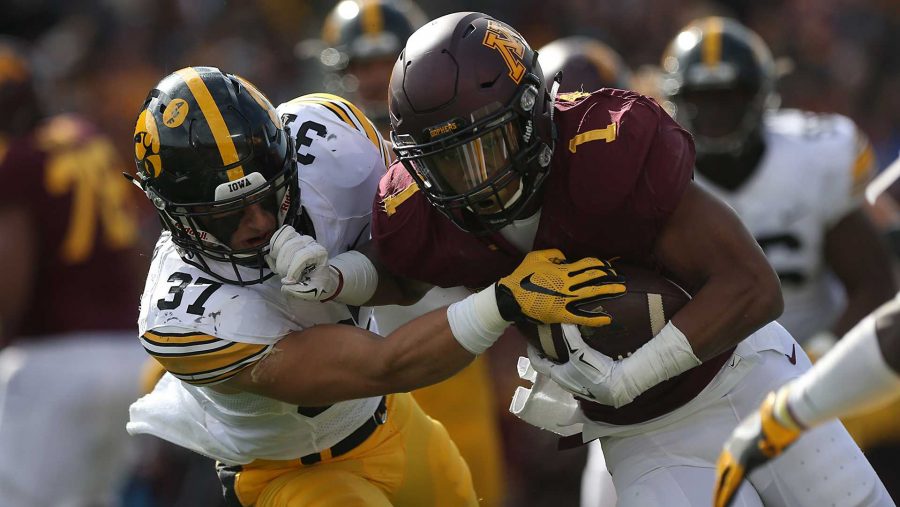 Iowa defensive back Brandon Snyder attempts to tackle Minnesota running back Rodney Smith during the Iowa-Minnesota game at TCF Banks Stadium in Minneapolis on Saturday, Oct. 8, 2016. The Hawkeyes defeated the Golden Gophers, 14-7. (The Daily Iowan/file photo)