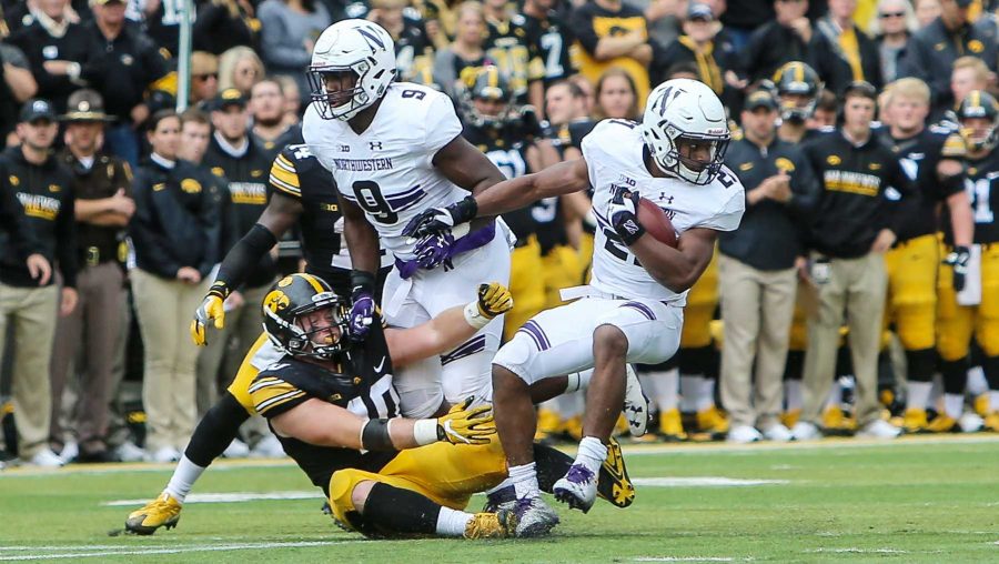 Northwestern running back Justin Jackson spins away from and Iowa defensive player during the Iowa v. Northwestern game at Kinnick Stadium on Saturday, Oct. 1, 2016. The Hawkeyes fell to the Wildcats 38-31. (The Daily Iowan/File photo)