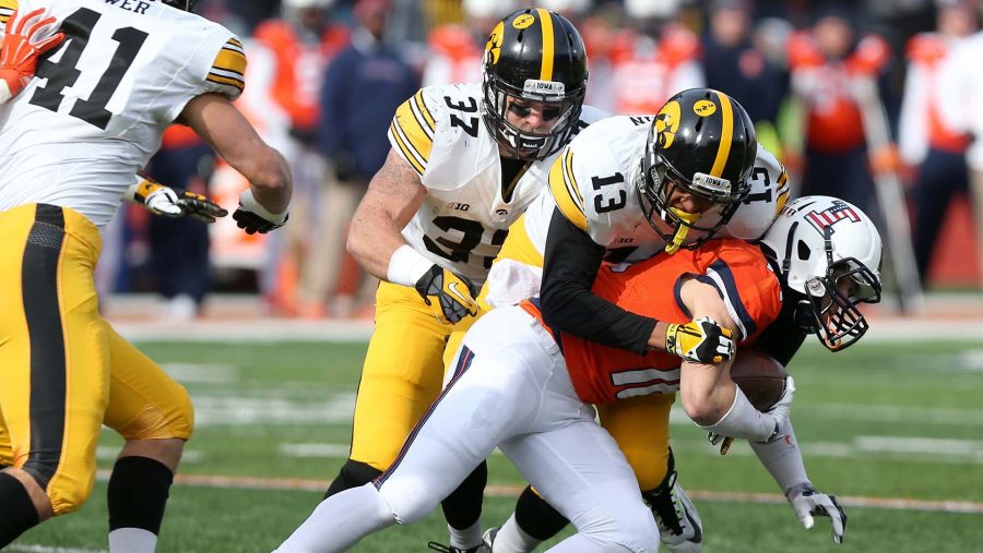 Iowa defensive back Greg Mabin tackles Illinois wide receiver Mike Dudek in Memorial Stadium on Saturday, November 15, 2014 in Champaign, Illinois. The Hawkeyes defeated the Fighting Illini, 30-14. (File photo/The Daily Iowan)