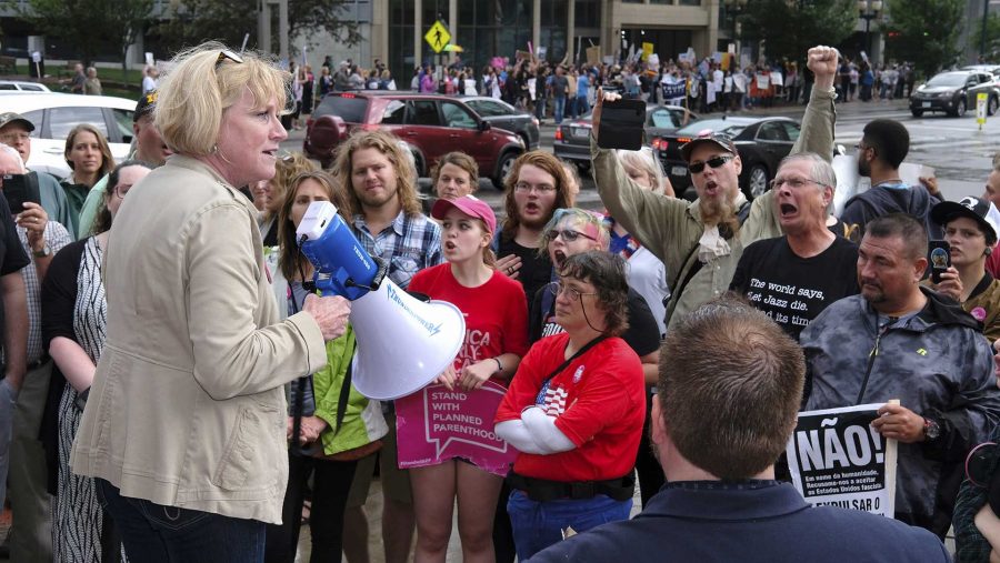Democratic+candidate+for+governor+Cathy+Glasson+addresses+protestors+outside+of+a+Donald+Trump+rally+in+Cedar+Rapids+on+Wednesday+June+21%2C+2017.+Glasson+is+president+of+SEIU+local+199%2C+a+union+chapter+representing+healthcare+workers+and+school+support+employees.+%28The+Daily+Iowan%2FNick+Rohlman%29