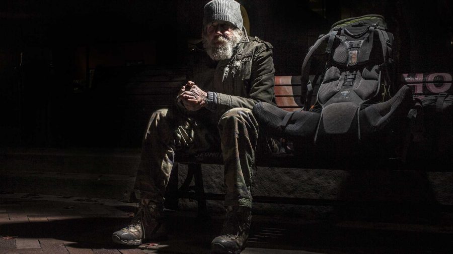 FILE - Ronal Alan Rarey, sits and listens to a singer in the Ped Mall on Monday, Nov. 9, 2015. Rarey is a homeless Vietnam veteran, he has been without a home for nearly seven years. (The Daily Iowan/file)