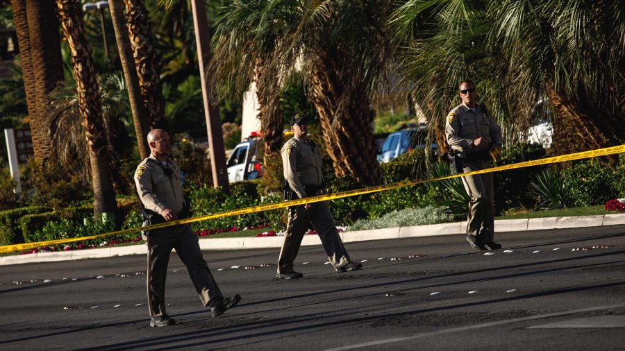 Law enforcement officers cordon off a crime scene after a gunman opened fire from an upper story of Mandalay Bay resort on a country music festival across the street on the Las Vegas Strip on Sunday night, leaving at least 58 dead and more than 500 injured, in Las Vegas, Nevada, on Oct. 2, 2017. (Marcus Yam/Los Angeles Times/TNS)