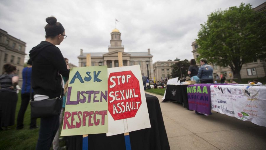 Community members participate in a march for Take Back the Night on Tuesday, April 25, 2017. Take Back the Night was a sexual assault awareness event. (The Daily Iowan/Joseph Cress)
