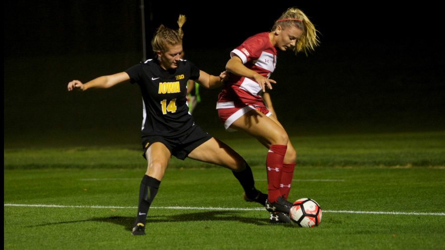 Iowa Defender Leah Moss challenges Chloe Knudtson along the touch line at the Iowa Soccer Complex in Iowa City on Saturday, October 21, 2017. The Hawkeyes fell to the Badgers 3-0. (Paxton Corey/The Daily Iowan)