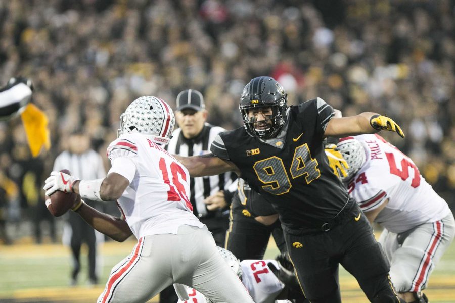 Iowa defensive end A.J. Epenesa goes for a sack against Ohio State quarterback J.T. Barrett during the Iowa/Ohio State football game in Kinnick Stadium on Saturday, Nov. 4, 2017. The Hawkeyes defeated the Buckeyes in a storming fashion, 55-24. (Joseph Cress/The Daily Iowan)