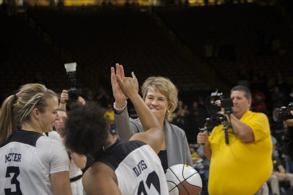 Iowa head coach Lisa Bluder high fives guard Tania Davis during the Iowa/Quinnipiac basketball game at Carver-Hawkeye Arena on Friday, Nov. 10, 2017. The Hawkeyes defeated the Bobcats, 83-67, for head coach Lisa Bluders 700 career win. (Lily Smith/The Daily Iowan)