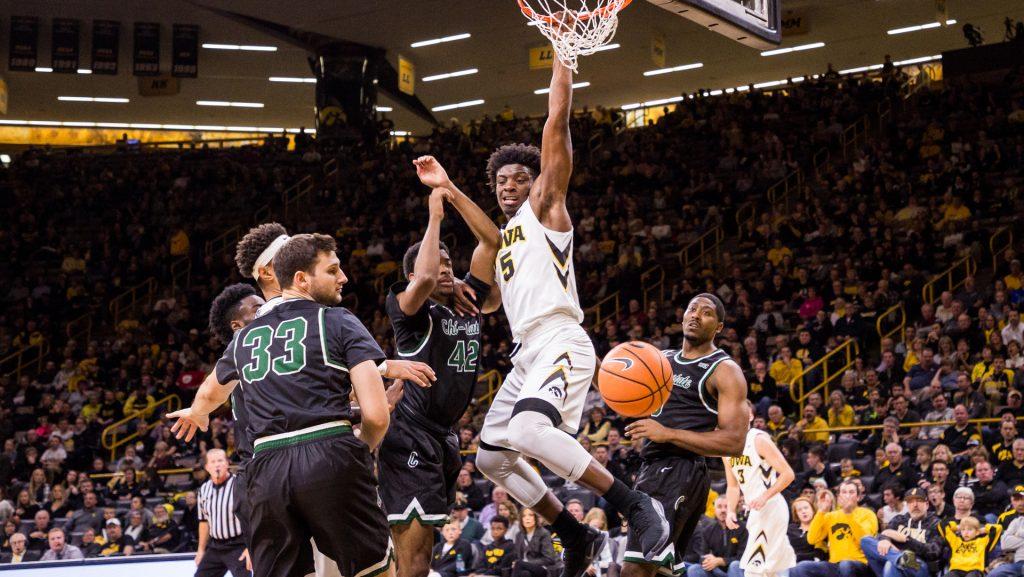 Iowa’s Tyler Cook hangs on the rim after dunking in a game against Chicago State University on Friday, 10. Nov, 2017. The Hawkeyes defeated the Cougars, 95-62. (David Harmantas/The Daily Iowan)