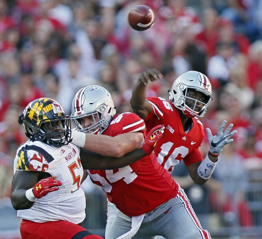 Ohio State quarterback J.T. Barrett (16) throws a pass while getting a block from offensive lineman Billy Price (54) against Maryland defensive lineman Oluwaseun Oluwatimi (57) in the first quarter at Ohio Stadium in Columbus, Ohio, on Saturday, Oct. 7, 2017. (Kyle Robertson/Columbus Dispatch/TNS)