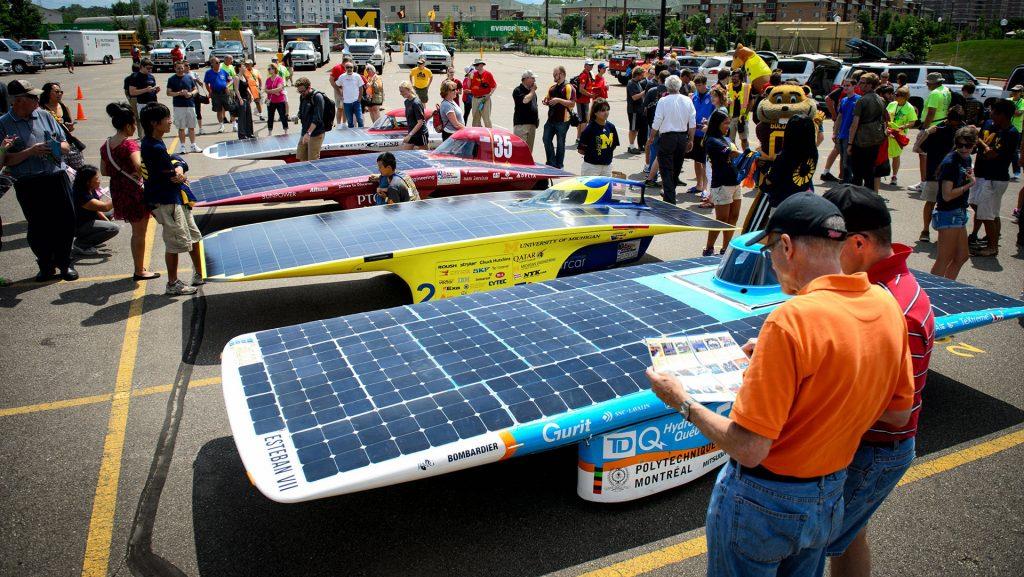 Crowds gather to observe the first four arriving solar cars from, left to right, Iowa State University, the University of Minnesota, the University of Michigan and Polytechnique Montreal during the American Solar Challenge on Monday, July 28, 2014. The solar car race ended at the University of Minnesota's East Bank campus in Minneapolis, Minn., with the University of Michigan taking first place. (Glen Stubbe/Minneapolis Star Tribune/MCT)
