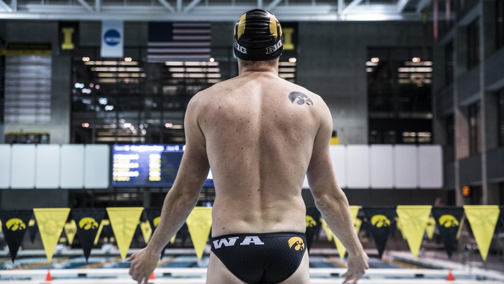 A member of the Iowa mens swim team stands on the blocks before his event during the Senior Day meet between Iowa and Minnesota at the Campus Recreation and Wellness Center on Friday, Oct. 27, 2017. The Iowa mens swimming team beat the 21st ranked Minnesota Golden Gophers 168-132. (Ben Smith/The Daily Iowan)