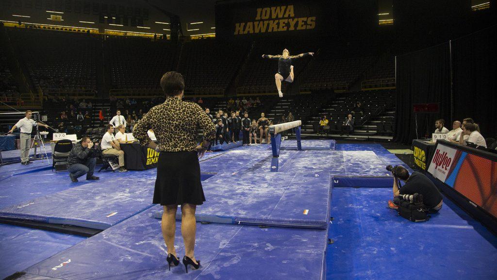 Iowa assistant coach Jennifer Green watches an Iowa gymnast perform on the balance beam during a womens gymnastics meet in Carver-Hawkeye Arena on Friday, Jan. 13, 2017. The Hawkeyes defeated the Spartans, 195.475-193.875. (The Daily Iowan/Joseph Cress)