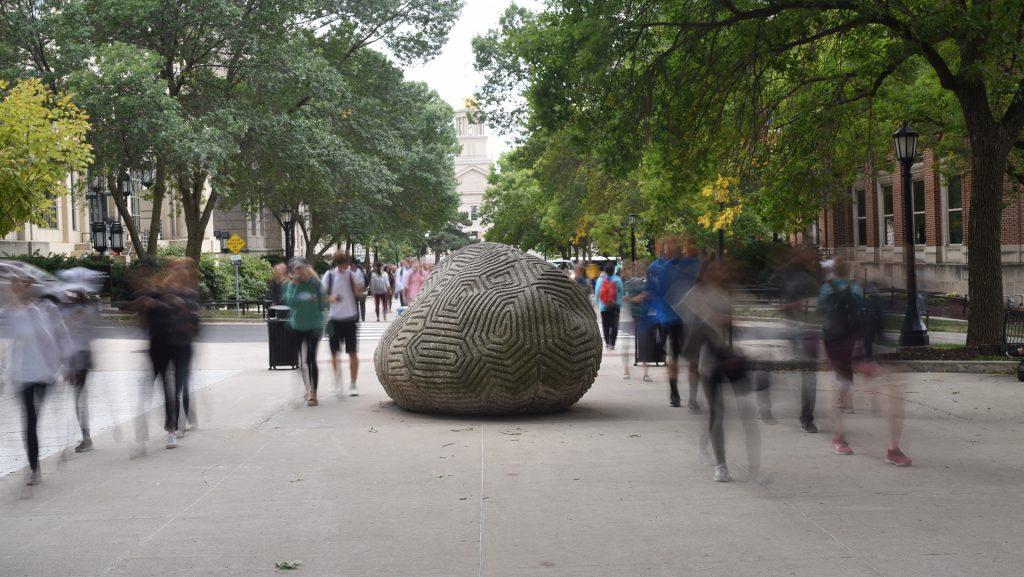 Students walk past the brain rock on the busy T. Anne Cleary Walkway Wednesday Sep 6, 2017.(Paxton Corey/The Daily Iowan)