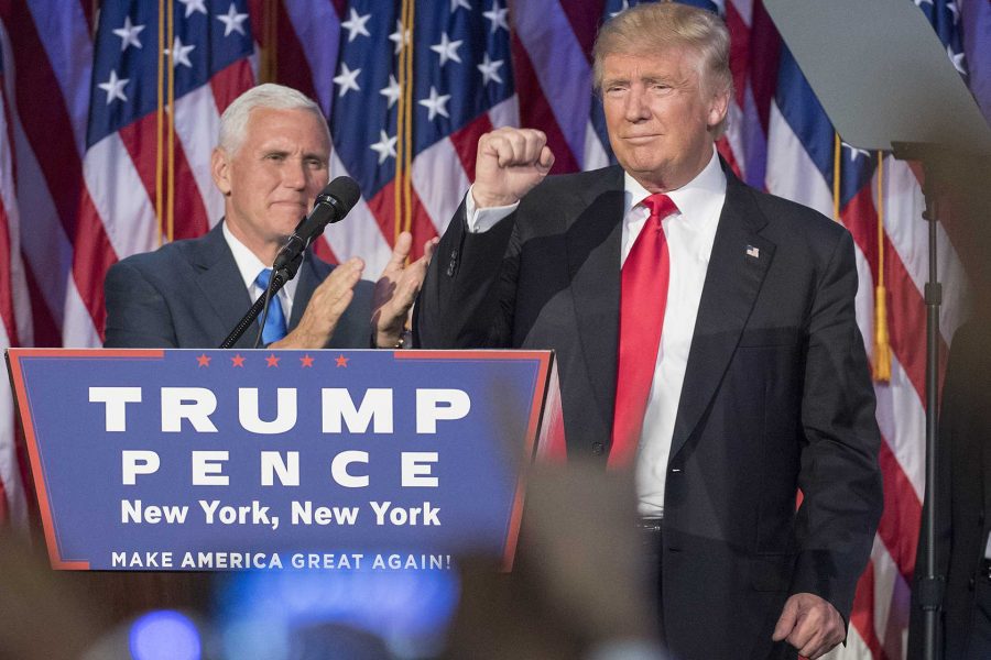 President-elect Donald Trump pumps his fist, with running mate Mike Pence standing by, following a speech to his supporters after winning the election at  the Election Night Party at the Hilton Midtown Hotel in New York City on Wednesday, Nov. 9, 2016. (J. Conrad Williams Jr./Newsday/TNS)