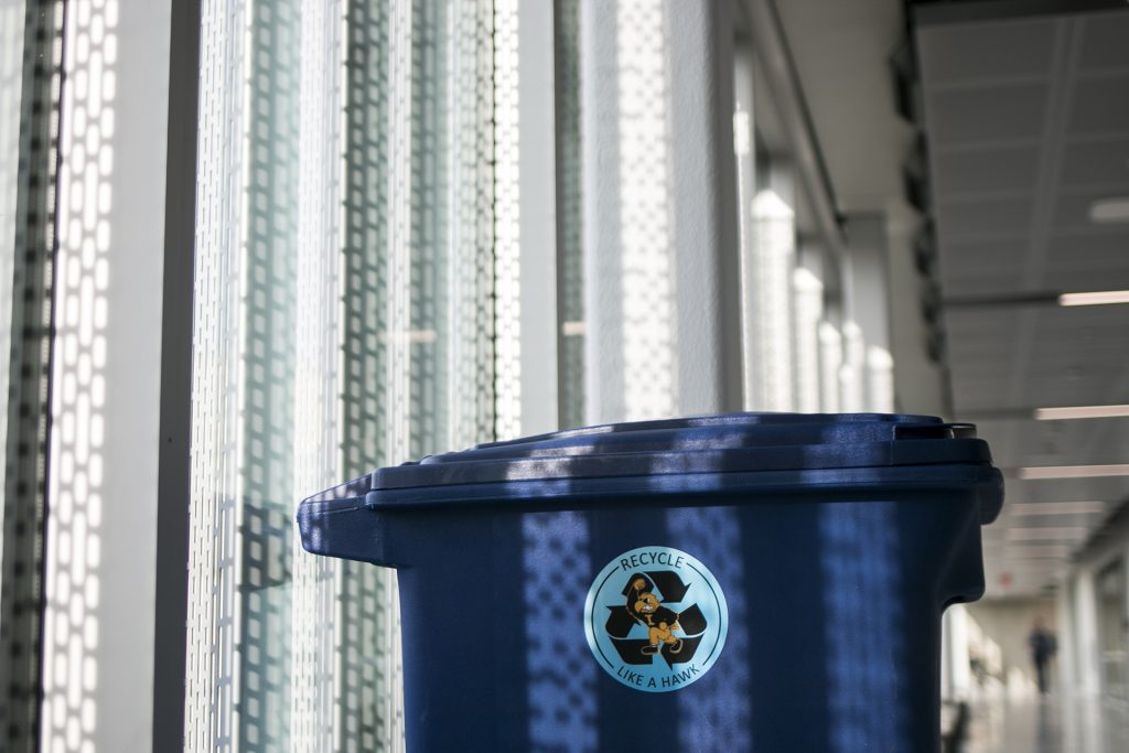 Blue recycling bins are seen inside the Seamans Center on Tuesday, Nov. 28, 2017. Seamans is in the process of undergoing a new recycling program to encourage students to recycle more recyclable products. (Joseph Cress/The Daily Iowan)