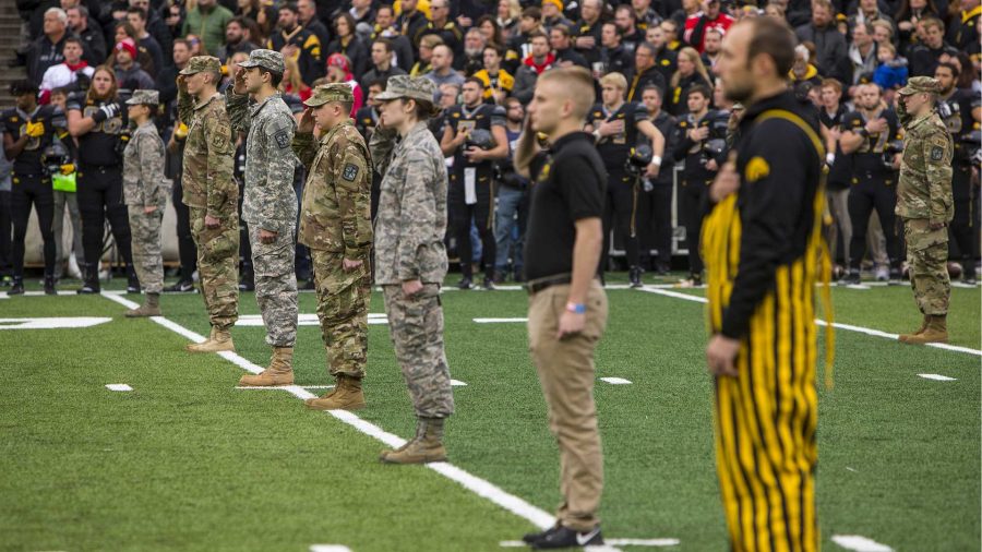 Veterans stand on the field during the national anthem before Iowas game against Ohio State at Kinnick Stadium on Saturday, Nov. 4, 2017. The Hawkeyes defeated the Buckeyes 55 to 24. (Nick Rohlman/The Daily Iowan)