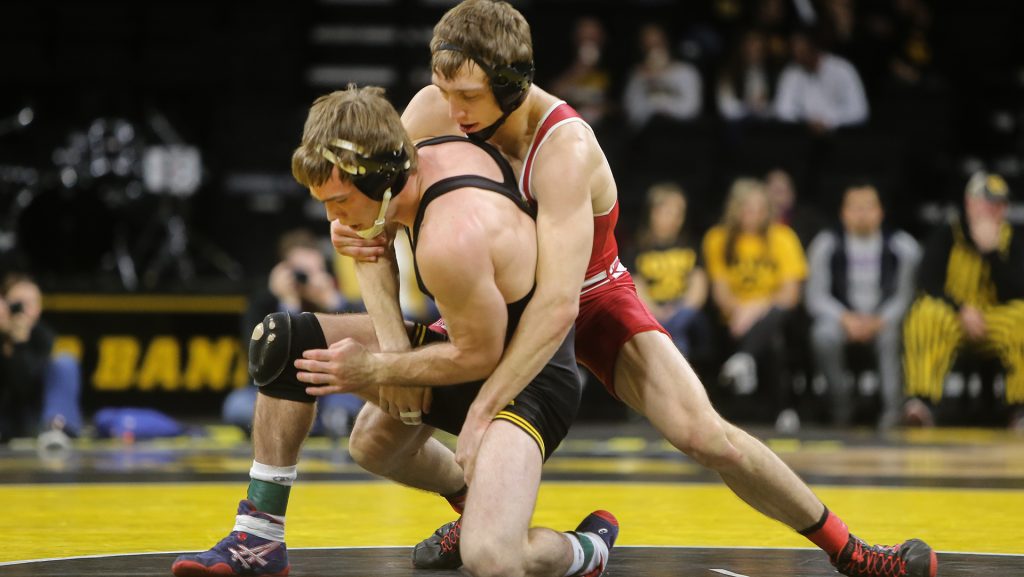 FILE - Iowas Brandon Sorenson tries to stop Wisconsins Andrew Crone during the Iowa v. Wisconsin wrestling bout, in Carver-Hawkeye  in Iowa City, Iowa  on Friday, Feb. 3, 2017. The Hawkeyes defeated the Badgers with a team overall of 33-8. (The Daily Iowan/file)