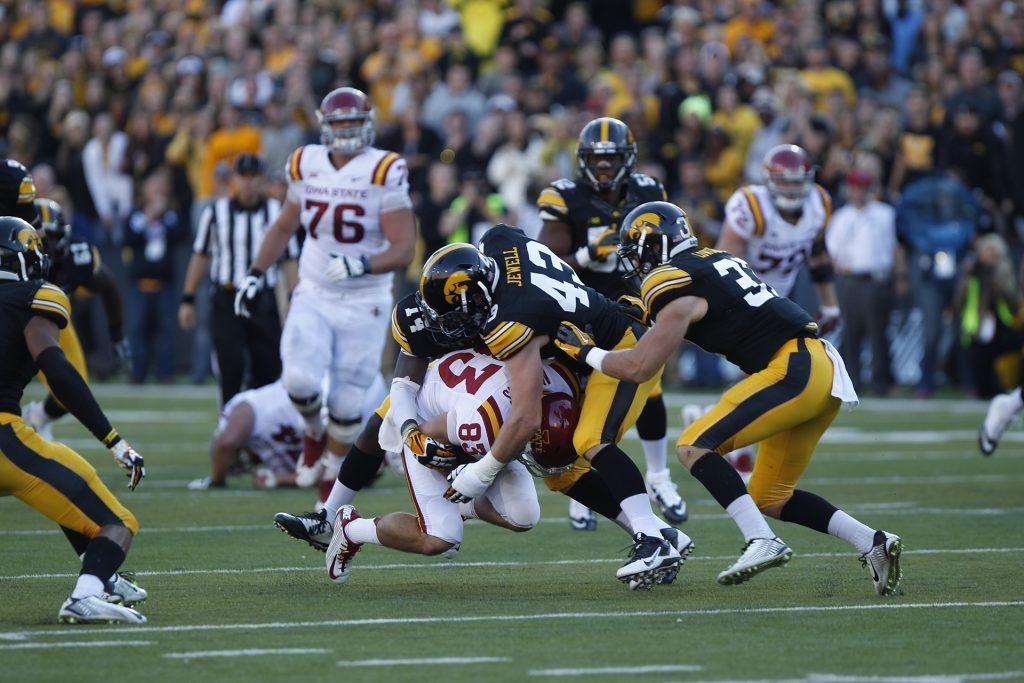 Iowa safety Desmond King and offensive linebacker Josey Jewell tackle Iowa State wide receiver Brett Medders in Kinnick Stadium on Saturday, Sept. 13, 2014. Iowa State defeated Iowa, 20-17. (The Daily Iowan/Valerie Burke)