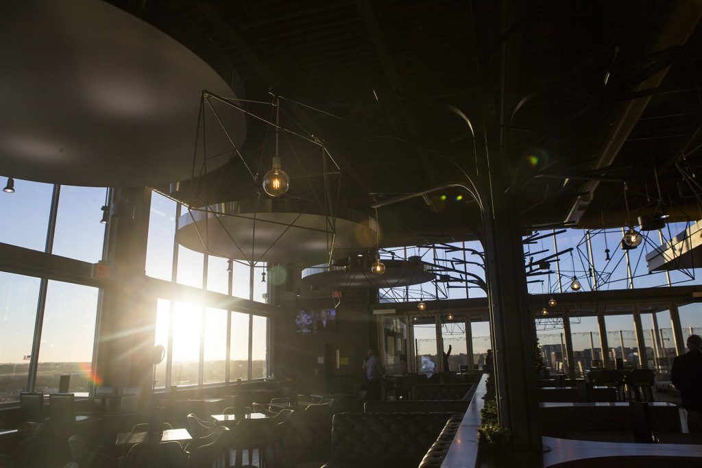 Sun fills into the 12th floor of the Vue bar and restaurant during a ribbon cutting event for the Hilton Garden Inn on Clinton Street on Thursday, Nov., 30, 2017. The hotel opened in October. (Joseph Cress/The Daily Iowan)